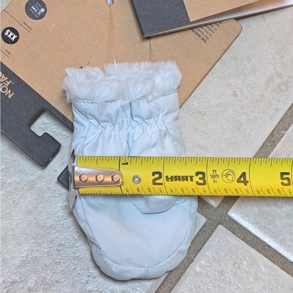 The North Face Littles Mossbud Swirl reversible mittens in a light blue color - Picture 4 of 10